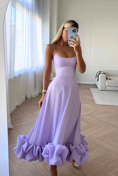 Elegant midi dress with thin straps and a flowing ruffle at the hem