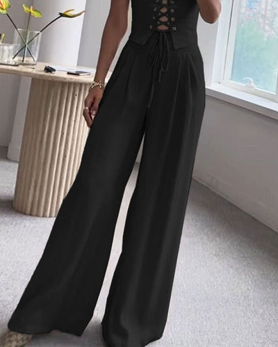 Two-piece set with a thin strap knotted top and flowing straight-leg pants