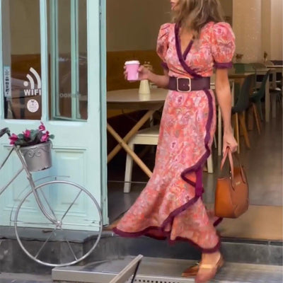 Elegant long dress with short puffed sleeves and asymmetrical skirt
