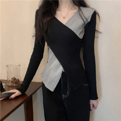 Black V-neck sweater with colored appliqués