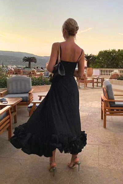 Elegant midi dress with thin straps and a flowing ruffle at the hem