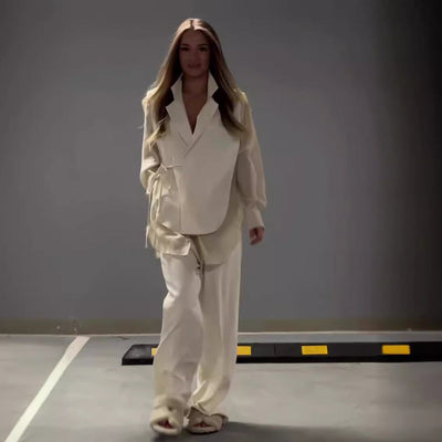 Modern outfit with asymmetrical long-sleeved blouse and wide-legged pants