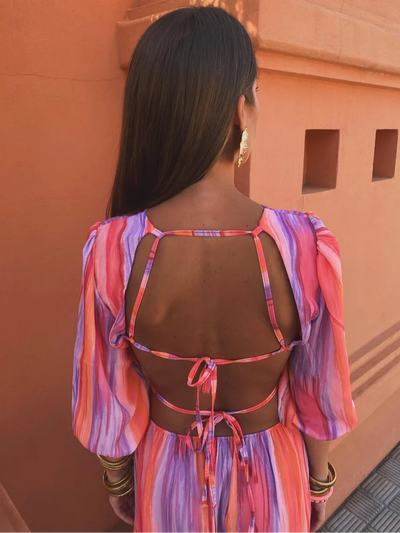 Elegant long dress with short puff sleeves and open back design