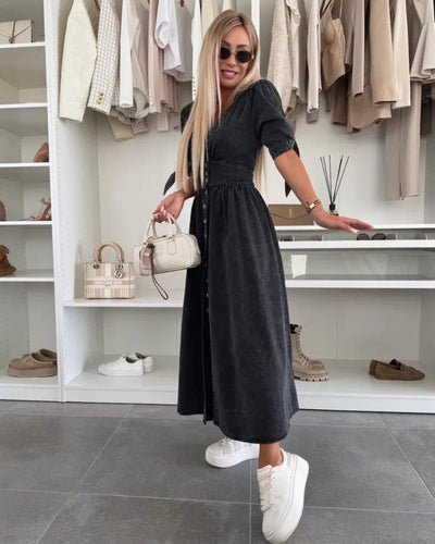 Elegant long dress with a deep neckline and three-quarter sleeves buttoned at the front