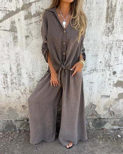 Elegant women's summer set with wide-legged trousers and a long-sleeved button-down blouse