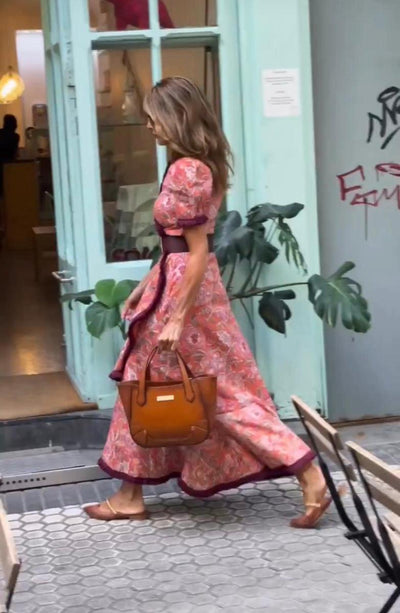 Elegant long dress with short puffed sleeves and asymmetrical skirt