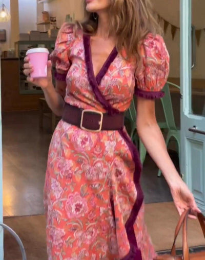 Elegant long dress with short puffed sleeves and asymmetrical skirt