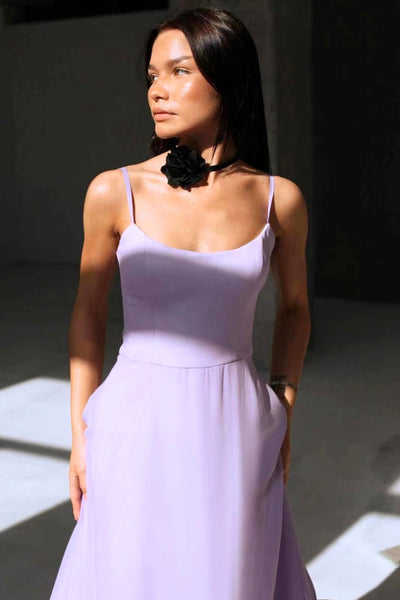Elegant midi dress with thin straps and a flowing ruffle at the hem