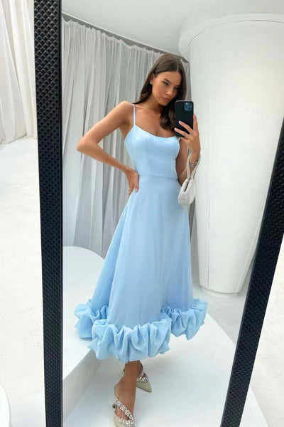 Elegant midi dress with thin straps and a flowing ruffle at the hem