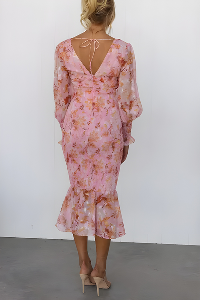 Flowy midi dress with long sleeves and a subtle floral print for an elegant look