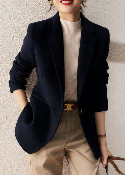 Loose-fitting navy coat with notched lapels and buttons, autumn
