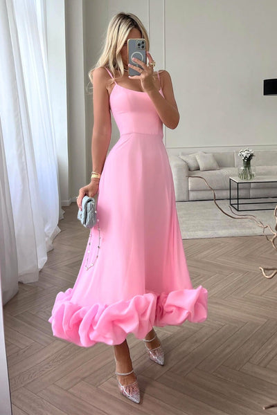 Elegant midi dress with thin straps and a flowing ruffle at the hem