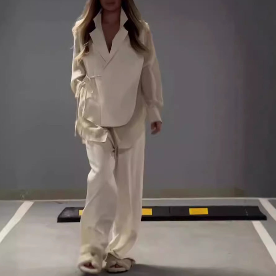 Modern outfit with asymmetrical long-sleeved blouse and wide-legged pants