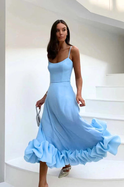 Elegant midi dress with thin straps and a flowing ruffle at the hem