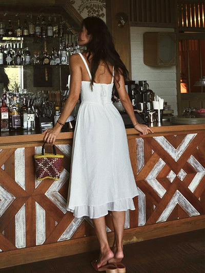 Plain midi dress with thin straps and ruffle at the hem