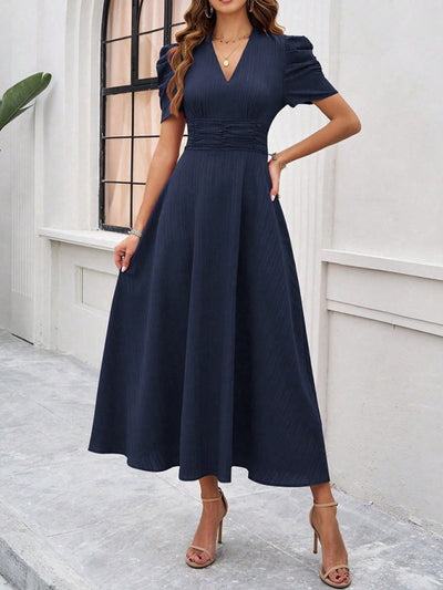 Midi cocktail dress with gathered waist, flared cut, and puff sleeves