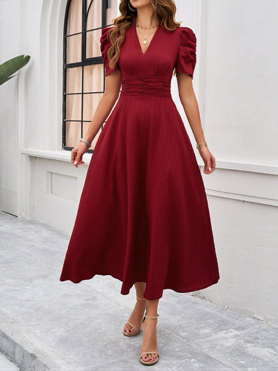 Midi cocktail dress with gathered waist, flared cut, and puff sleeves