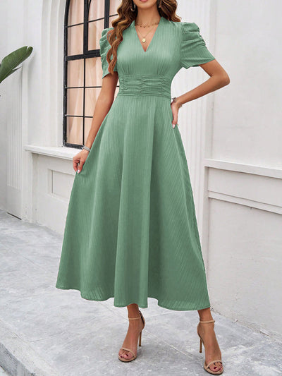 Midi cocktail dress with gathered waist, flared cut, and puff sleeves