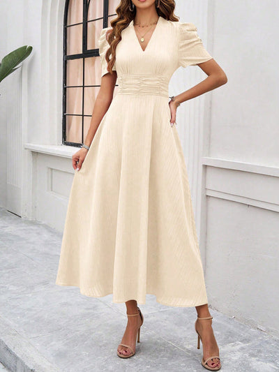 Midi cocktail dress with gathered waist, flared cut, and puff sleeves