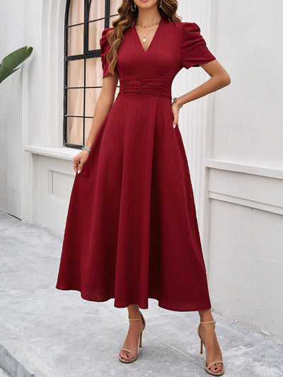 Midi cocktail dress with gathered waist, flared cut, and puff sleeves