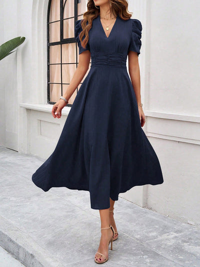 Midi cocktail dress with gathered waist, flared cut, and puff sleeves
