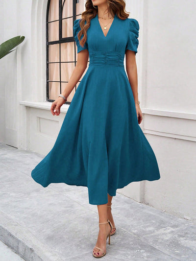 Midi cocktail dress with gathered waist, flared cut, and puff sleeves