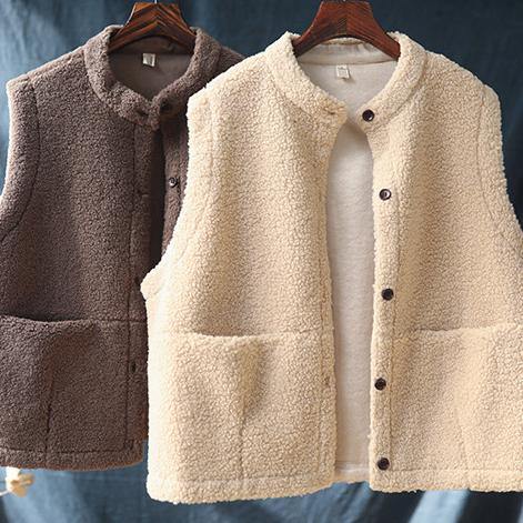 Elegant warm women's vest in nude color with large pockets and buttons