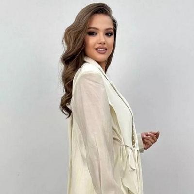 Modern outfit with asymmetrical long-sleeved blouse and wide-legged pants