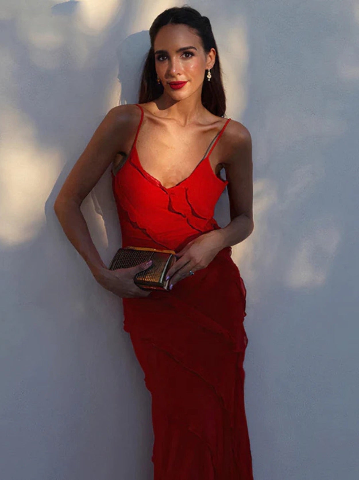 Elegant long dress with ruffles and thin straps, ideal for special occasions