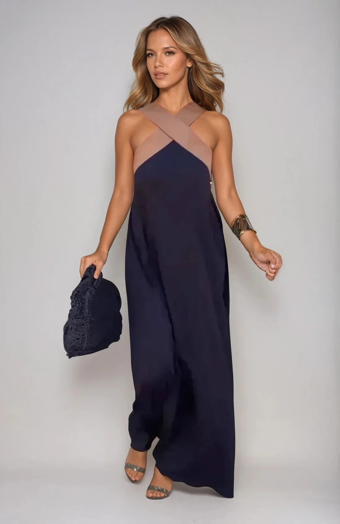 Long sleeveless dress with elegant neckline and modern cut