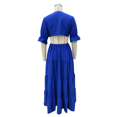 Long summer dress with flared sleeves, a deep neckline, and a cut at the waist