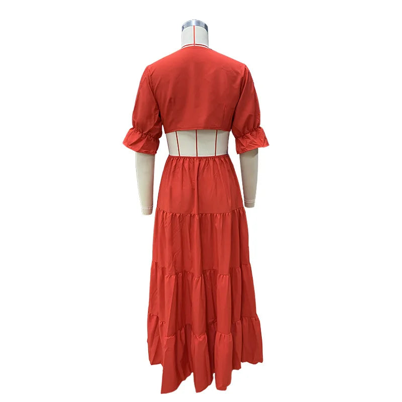 Long summer dress with flared sleeves, a deep neckline, and a cut at the waist