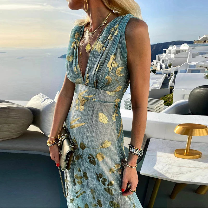 Long flowing dress with V-neckline and details with shiny elements