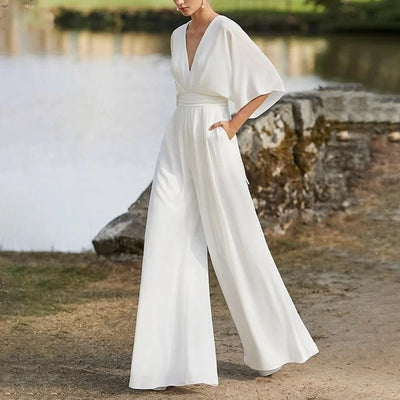 Elegant women's jumpsuit with a plunging neckline, wide sleeves, and wide-legged pants