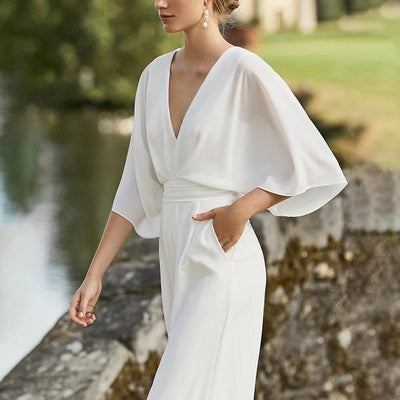 Elegant women's jumpsuit with a plunging neckline, wide sleeves, and wide-legged pants