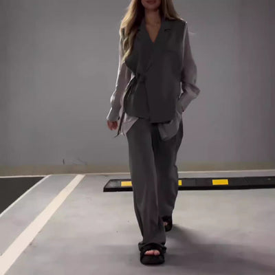 Modern outfit with asymmetrical long-sleeved blouse and wide-legged pants