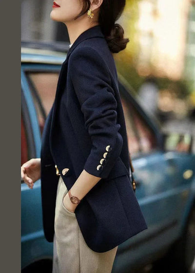 Loose-fitting navy coat with notched lapels and buttons, autumn