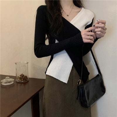 Black V-neck sweater with colored appliqués