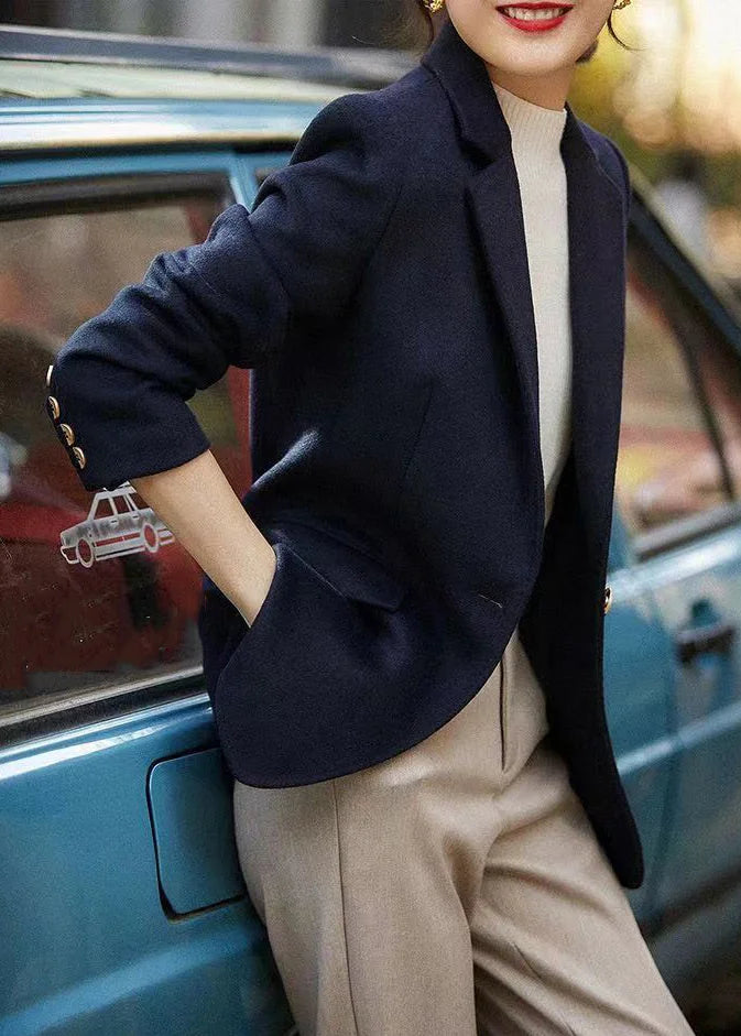 Loose-fitting navy coat with notched lapels and buttons, autumn