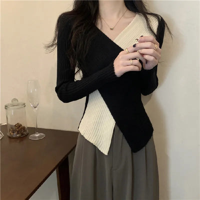 Black V-neck sweater with colored appliqués