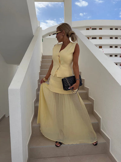 Elegant women's set with a long pleated skirt and a buttoned vest