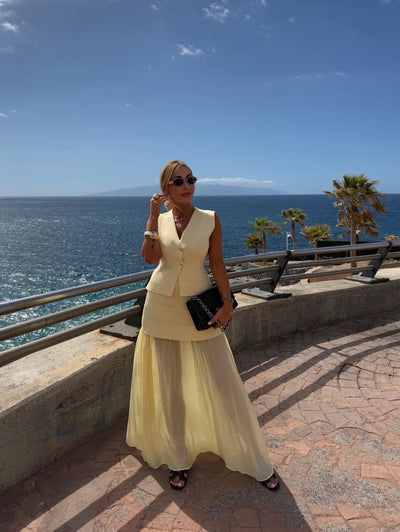 Elegant women's set with a long pleated skirt and a buttoned vest