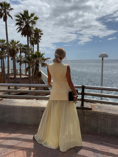 Elegant women's set with a long pleated skirt and a buttoned vest