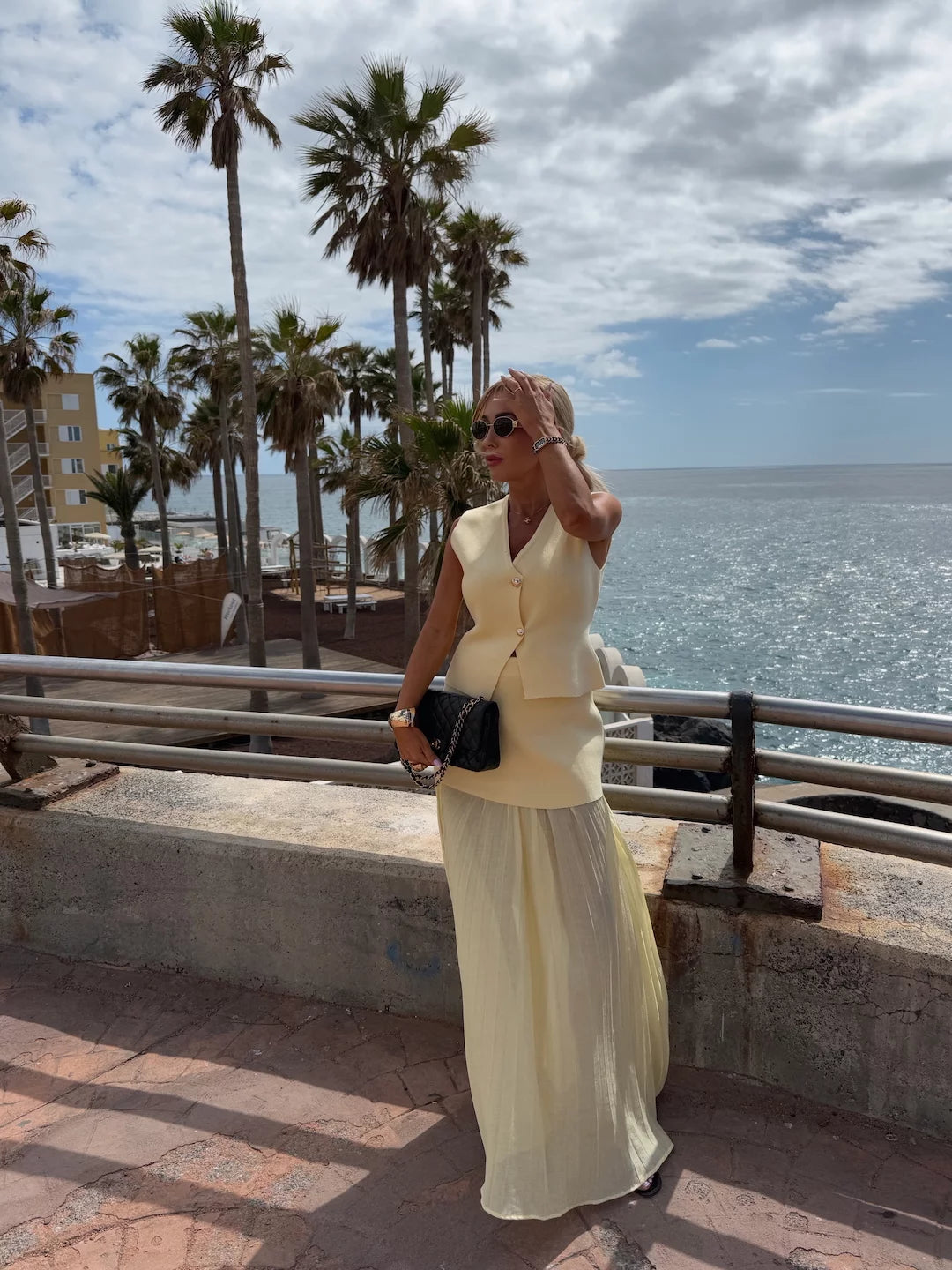Elegant women's set with a long pleated skirt and a buttoned vest