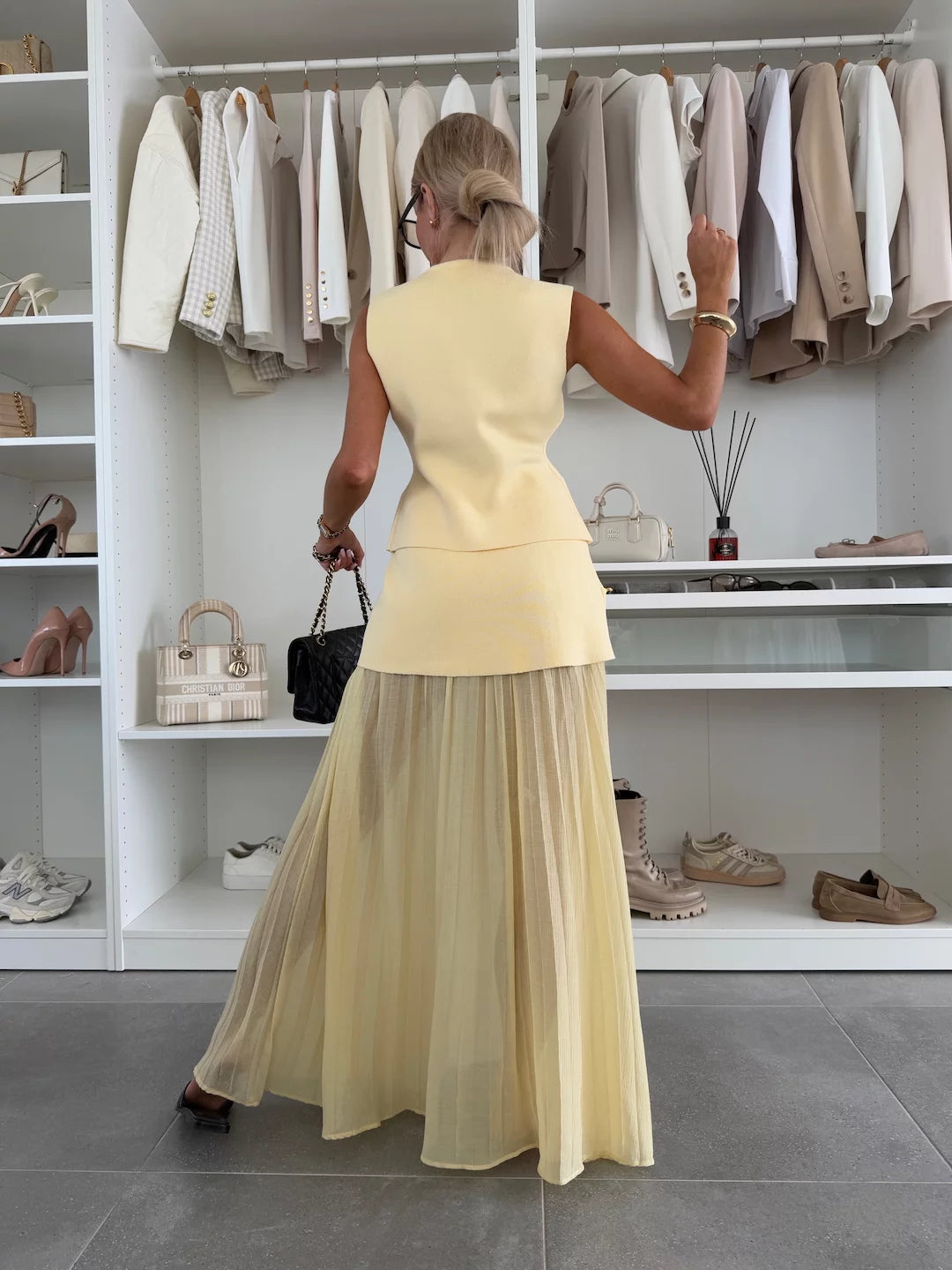 Elegant women's set with a long pleated skirt and a buttoned vest