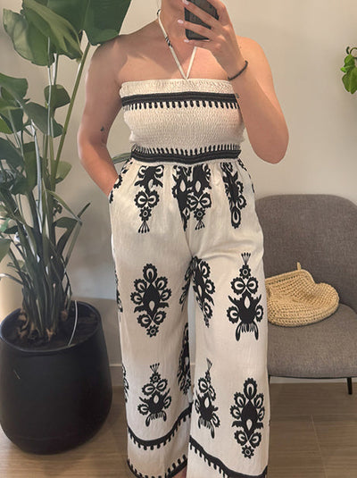 Women's wide-cut jumpsuit with a neck strap and printed trousers