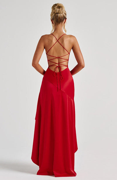 Long evening dress with thin straps, high slit, and asymmetrical hem