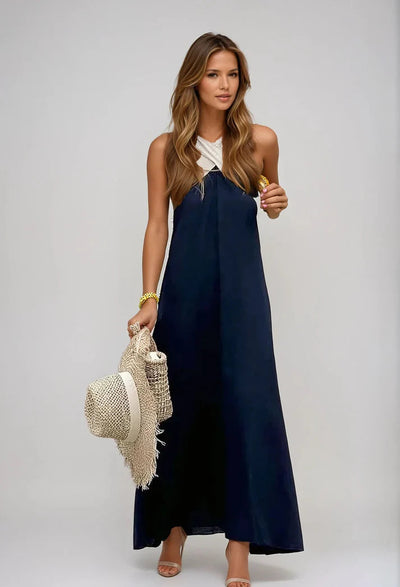 Long sleeveless dress with elegant neckline and modern cut